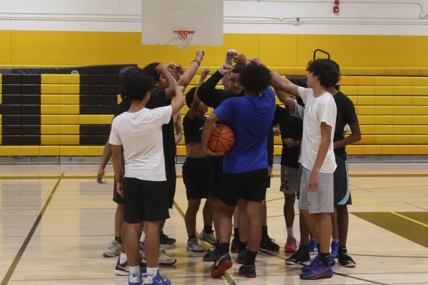 Dons JV team in a group huddle after practice.