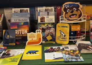 Display of brochures and infographics on the Universities of California, located by the College and Career Center. 